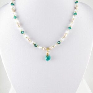 Emerald and gold necklace on bust
