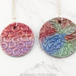 Unique reversible pendants made with polymer clay and mica powders. 13 Reversible pendants made with polymer clay.